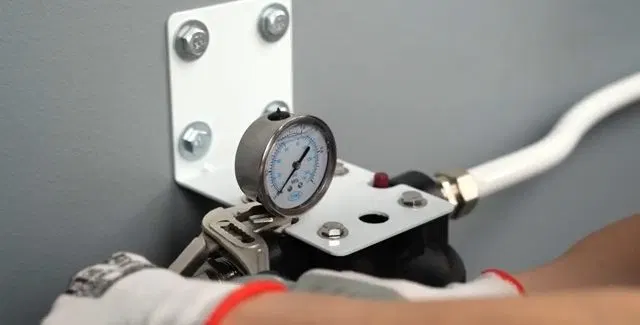 Checking Filter Bracket Pressure Gauge shown for Is Dallas, GA's Water Actually Hard Enough to Need a Softener? in Dallas, Georgia.