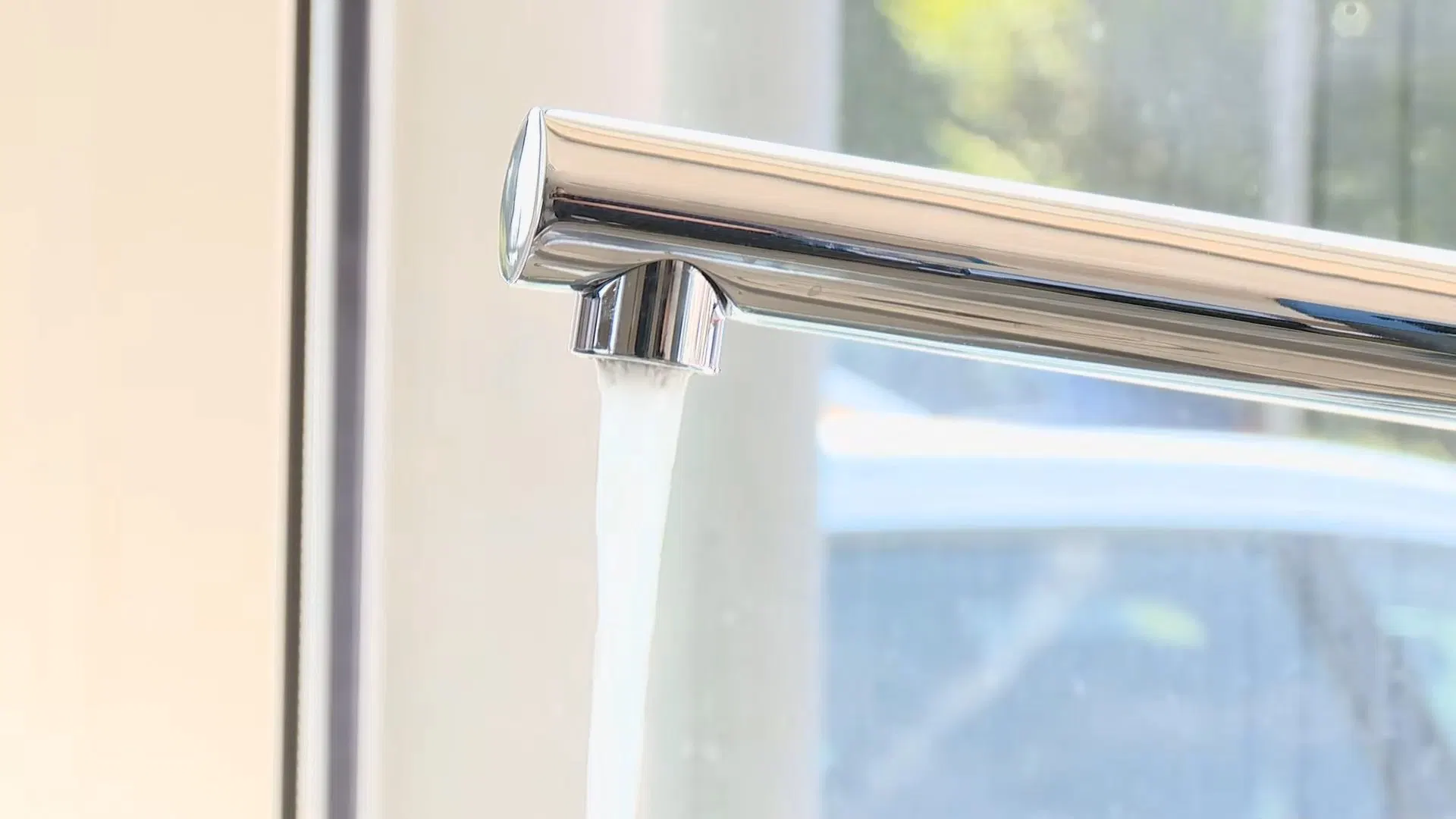 Chrome Kitchen Faucet Beside Window shown for Plumber in Dallas, GA in Dallas, Georgia.