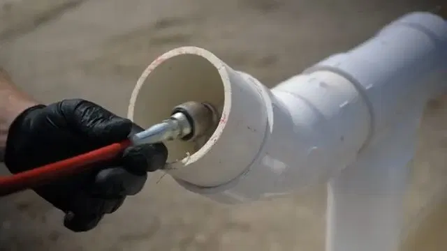 Connecting Hydro Jet Nozzle To Hose shown for Is a Slow Drain an Emergency on a Dallas, GA Septic System? in Dallas, Georgia.