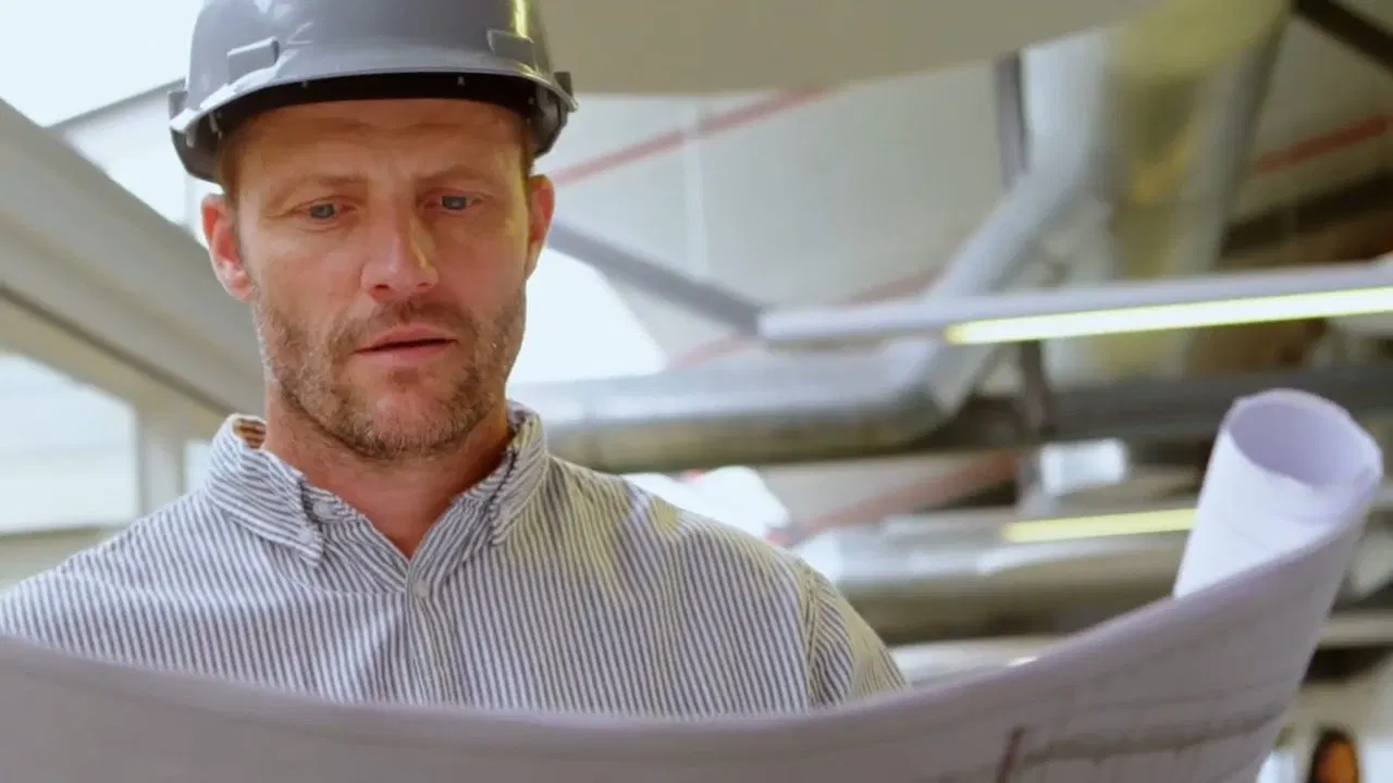 Contractor Reviewing Plumbing Takeoff Plans shown for A Running Toilet on a Septic System: What It's Actually Costing You in Dallas, Georgia.