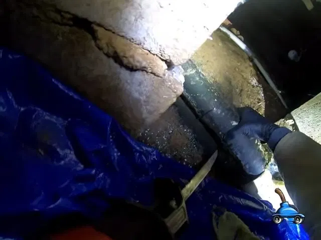 Cutting Damaged Crawlspace Sewer Pipe shown for Plumbing services in Dallas, GA in Dallas, Georgia.