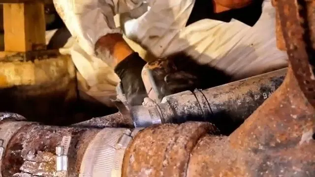 Cutting Rusted Cast Iron Drain With Reciprocating Saw shown for Drain Cleaning in Dallas, GA in Dallas, Georgia.