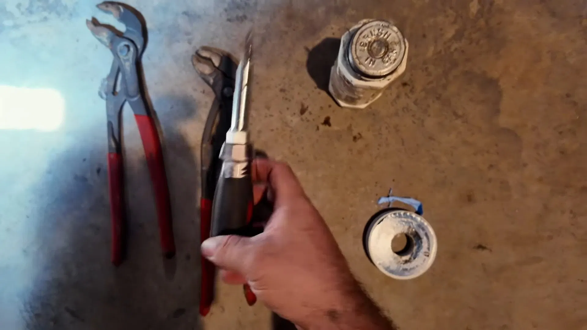 Disconnecting Old Gas Water Heater Hose shown for Gas Line Installation & Repair in Dallas, GA in Dallas, Georgia.
