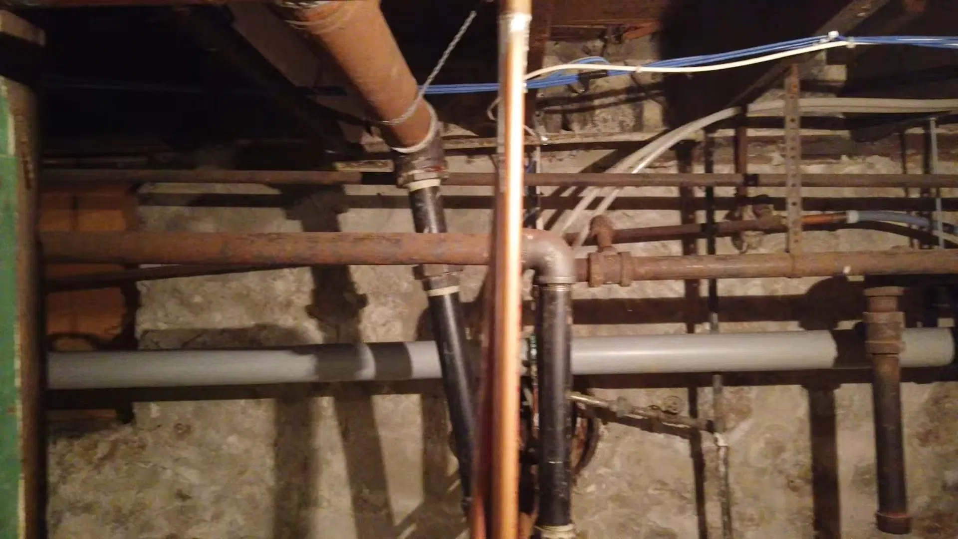 Exposed Basement Water Pipes Between Joists shown for Water Bill Spike in Dallas, GA: Is It a Leak? in Dallas, Georgia.