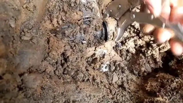 Exposed Broken Water Line Under Muddy Water shown for The First Five Minutes of a Burst Pipe in a Dallas, GA Home in Dallas, Georgia.