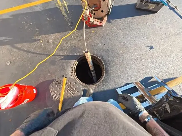 Feeding Drain Snake Into Restaurant Floor Drain shown for Opening a Restaurant Along Dallas, GA's Highway 61 Corridor: What to Check First in Dallas, Georgia.