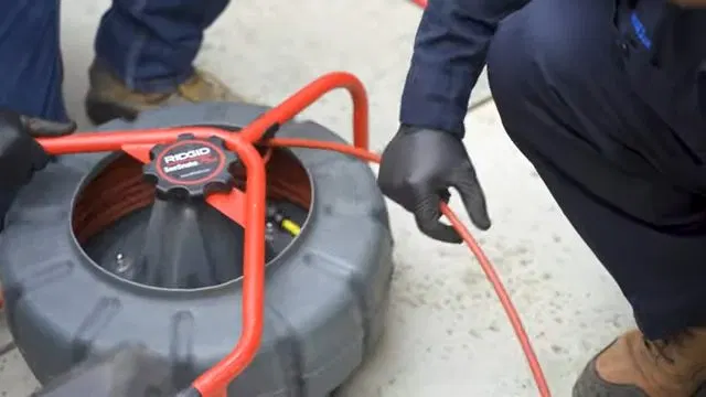 Feeding Inspection Camera Into Sewer Cleanout shown for Sewer Line Repair & Replacement in Dallas, GA in Dallas, Georgia.