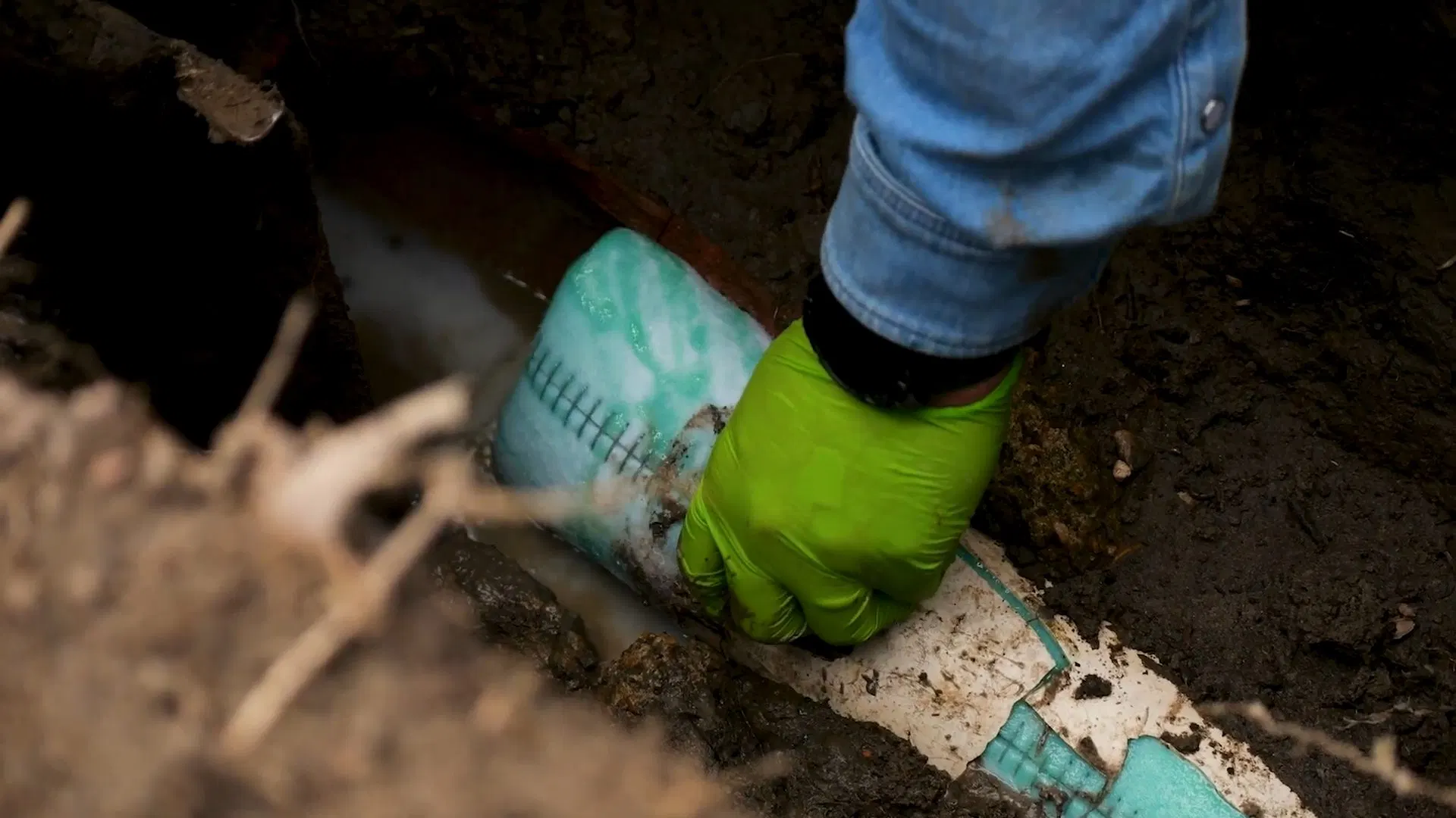 Gloved Worker Preparing Underground Pipe Liner shown for What Size Water Heater Does a Dallas, GA Household Actually Need? in Dallas, Georgia.