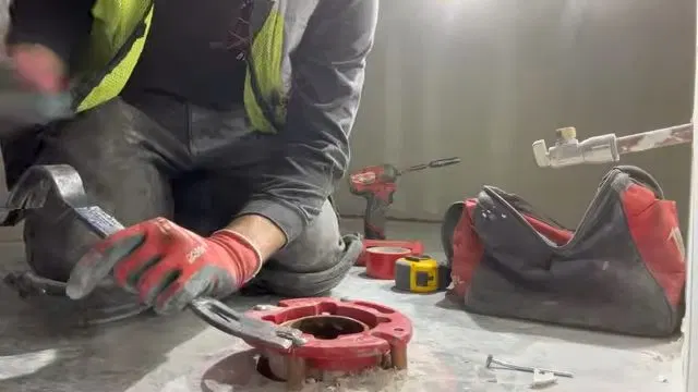 Grinding Commercial Toilet Flange At Floor shown for A Running Toilet on a Septic System: What It's Actually Costing You in Dallas, Georgia.