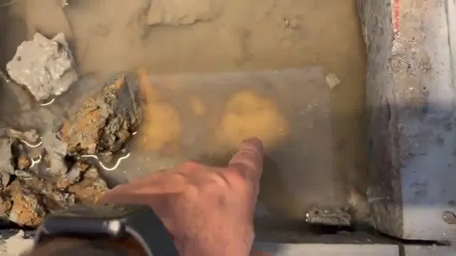 Hand Pointing At Concrete Slab Leak shown for Slab Leak Detection & Repair in Dallas, GA in Dallas, Georgia.