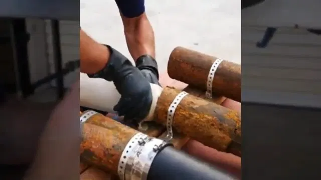Handling Cured Sewer Liner At Cut Pipe shown for What Size Water Heater Does a Dallas, GA Household Actually Need? in Dallas, Georgia.
