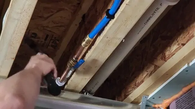 Installing Blue And Red PEX Lines In Joists shown for How Long Should a Water Heater Actually Last in Dallas, GA? in Dallas, Georgia.