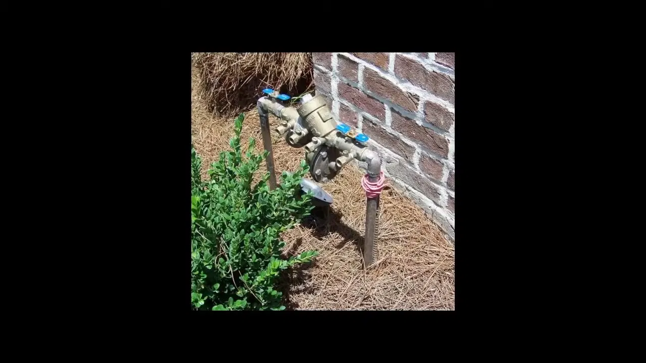 Irrigation Backflow Valves Beside Brick Wall shown for Contact Plumbing Pros Dallas GA in Dallas, Georgia.