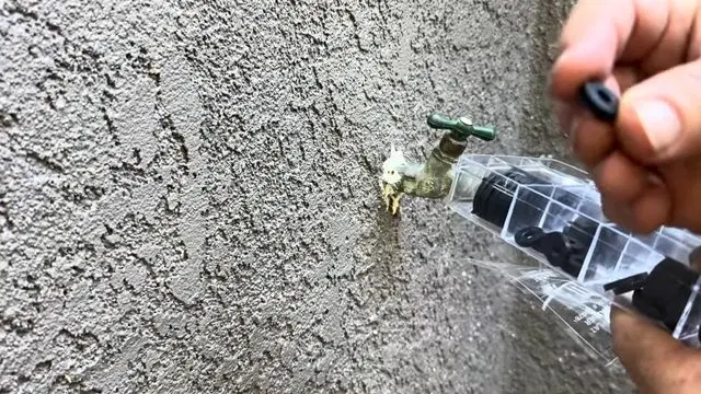 Leaking Exterior Hose Bib On Stucco Wall shown for How Long Should a Water Heater Actually Last in Dallas, GA? in Dallas, Georgia.