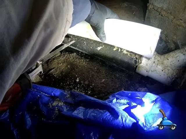 Locating Crawlspace Sewer Joint With Flashlight shown for How Long Should a Water Heater Actually Last in Dallas, GA? in Dallas, Georgia.