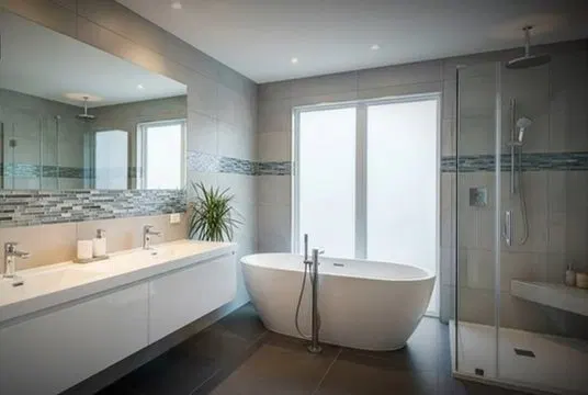 Luxury Bathroom Remodel With Glass Shower shown for How Long Should a Water Heater Actually Last in Dallas, GA? in Dallas, Georgia.