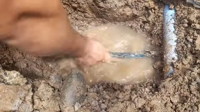 Muddy Ground Around Burst Water Line shown for The First Five Minutes of a Burst Pipe in a Dallas, GA Home in Dallas, Georgia.