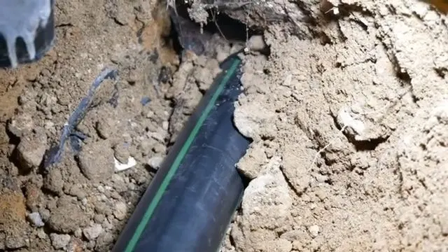 New Black Sewer Pipe Installed In Slab Trench shown for Leak Detection in Dallas, GA in Dallas, Georgia.