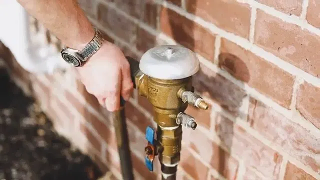 Opening Backflow Test Port On Brass Valve shown for Plumbing services in Dallas, GA in Dallas, Georgia.