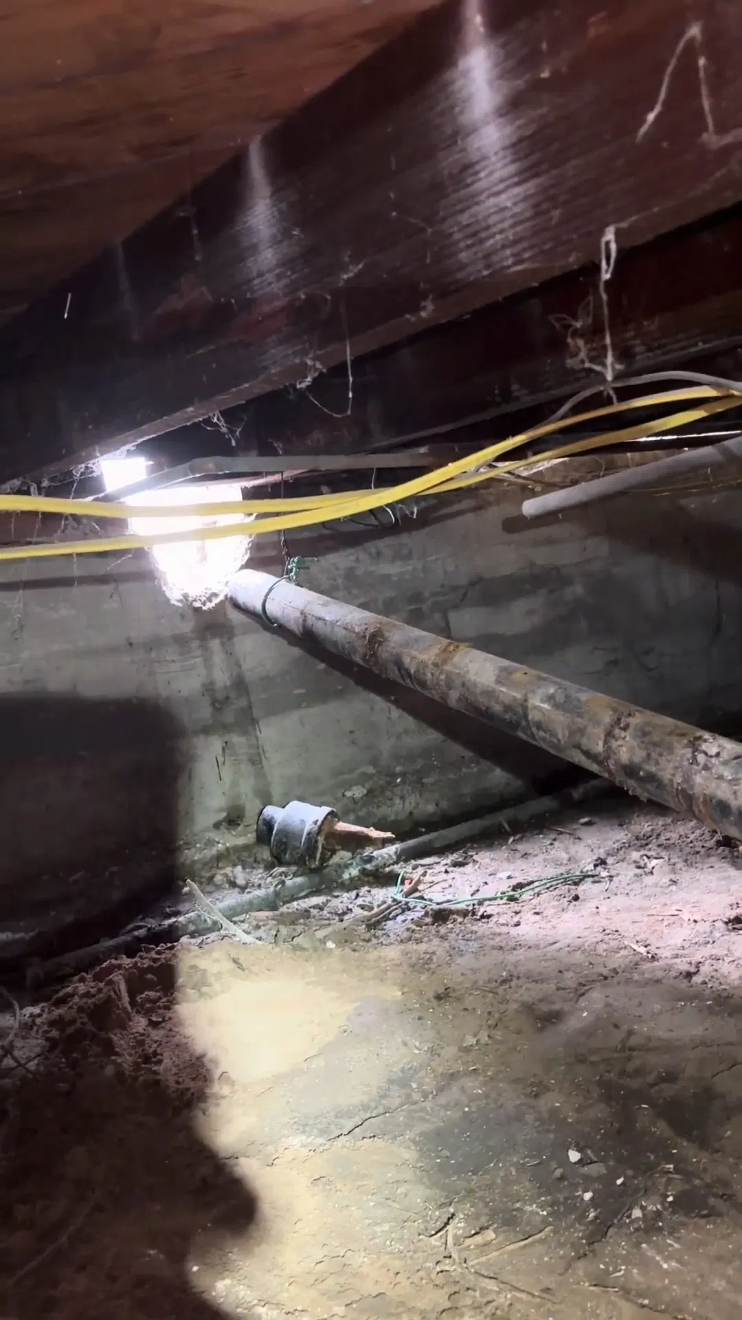 Plumber Crawling Through Low Clearance Space shown for Is Tankless Worth It for a Dallas, GA Home on Propane? in Dallas, Georgia.