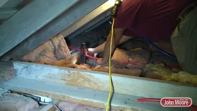Plumber Soldering New Pipe In Attic shown for Is Tankless Worth It for a Dallas, GA Home on Propane? in Dallas, Georgia.