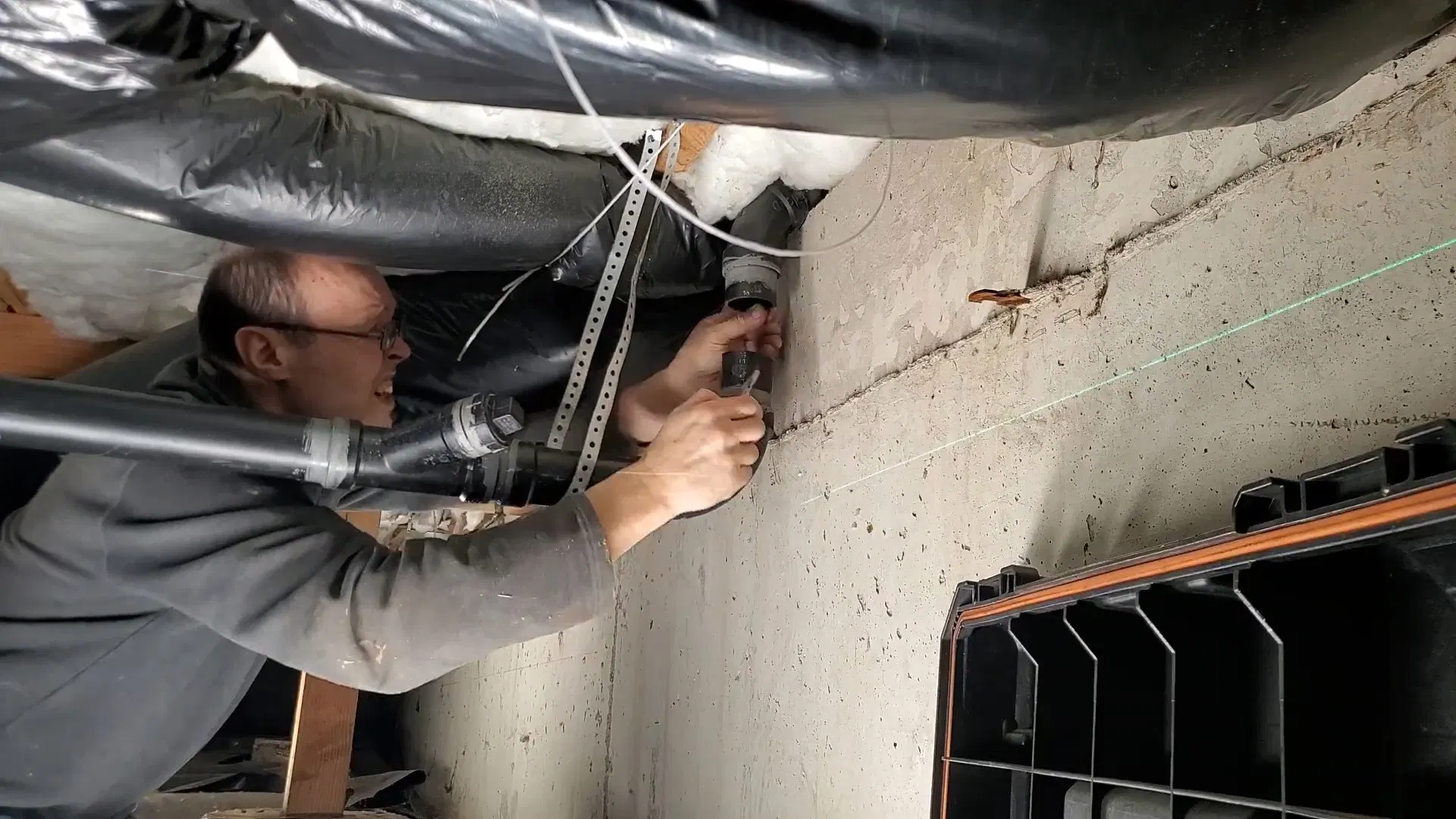 Plumber Working Beneath Floor Joists shown for Is Tankless Worth It for a Dallas, GA Home on Propane? in Dallas, Georgia.