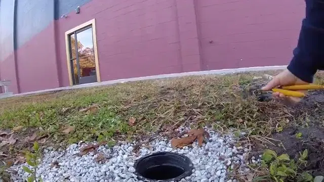 Positioning Camera Cable At Sewer Access shown for Sewer Line Repair & Replacement in Dallas, GA in Dallas, Georgia.