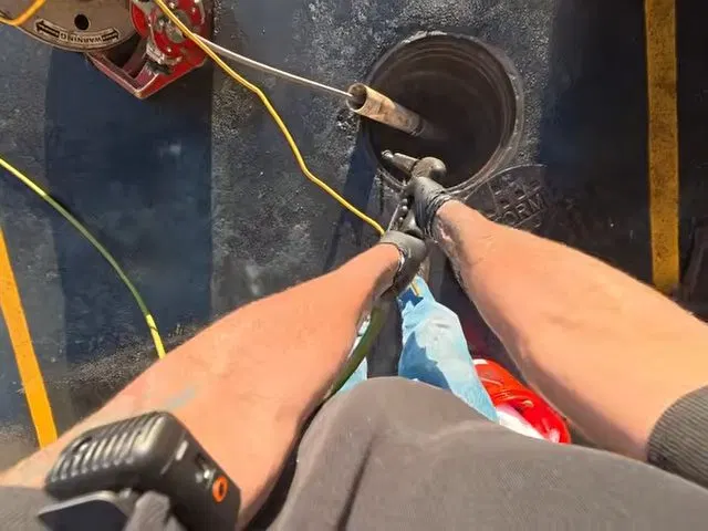 Pulling Drain Cable From Commercial Cleanout shown for Hydro Jetting in Dallas, GA in Dallas, Georgia.