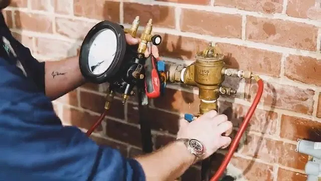 Reading Gauge During Backflow Valve Test shown for Plumbing services in Dallas, GA in Dallas, Georgia.