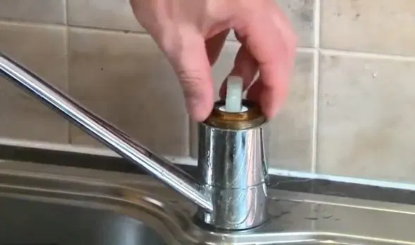 Reinstalling Kitchen Faucet Control Cap shown for Plumber in Dallas, GA in Dallas, Georgia.