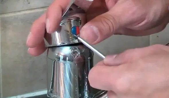 Removing Faucet Cartridge Retaining Screw shown for Why Does Our Faucet Keep Dripping After We Already Fixed It? in Dallas, Georgia.