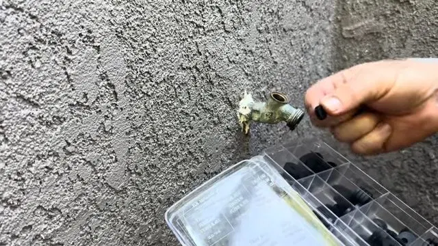 Removing Hose Bib Screw With Driver shown for Why Does Our Faucet Keep Dripping After We Already Fixed It? in Dallas, Georgia.