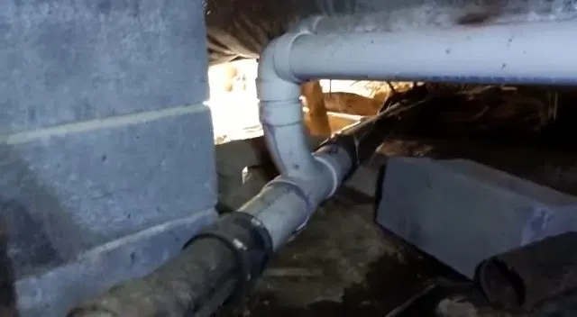 Repaired PVC Drain Elbow Under House shown for How Often Does a Septic Tank Actually Need Pumping in Paulding County? in Dallas, Georgia.