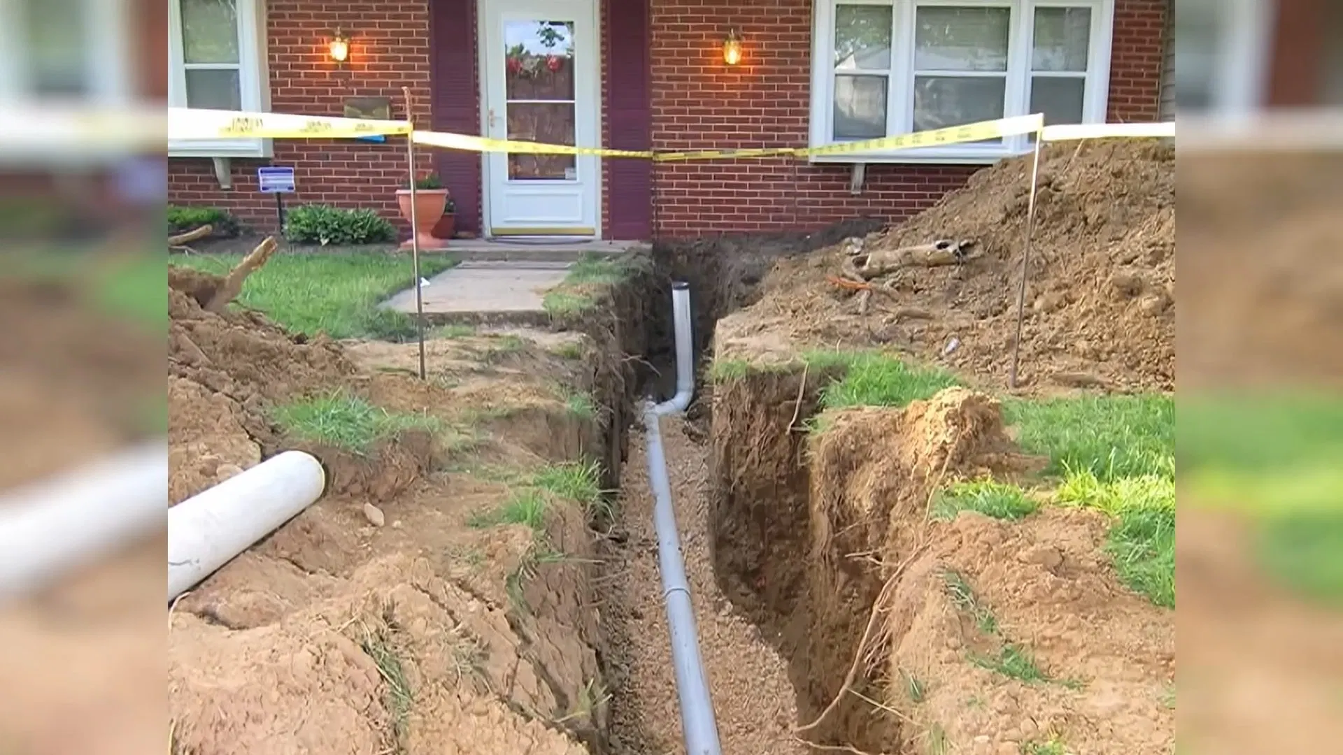 Sewer Pipe Lining Hose Over Front Lawn shown for The First Five Minutes of a Burst Pipe in a Dallas, GA Home in Dallas, Georgia.