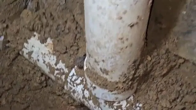 Soil Covered PVC Sewer Wye Connection shown for Why Does Our Drain Keep Clogging Again After It's Been Snaked? in Dallas, Georgia.
