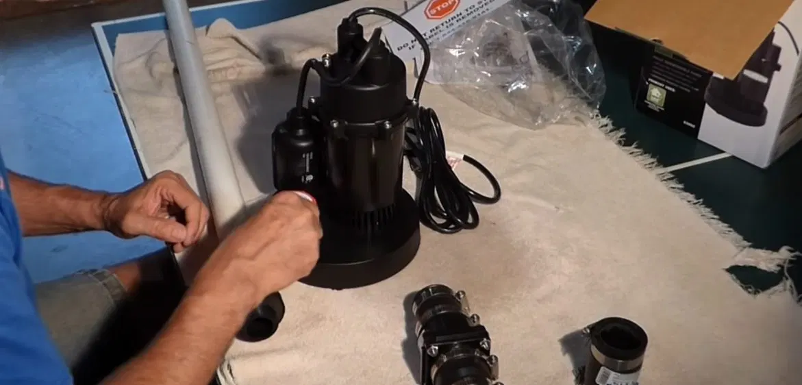 Sump Pump Components Held Before Install shown for Contact Plumbing Pros Dallas GA in Dallas, Georgia.
