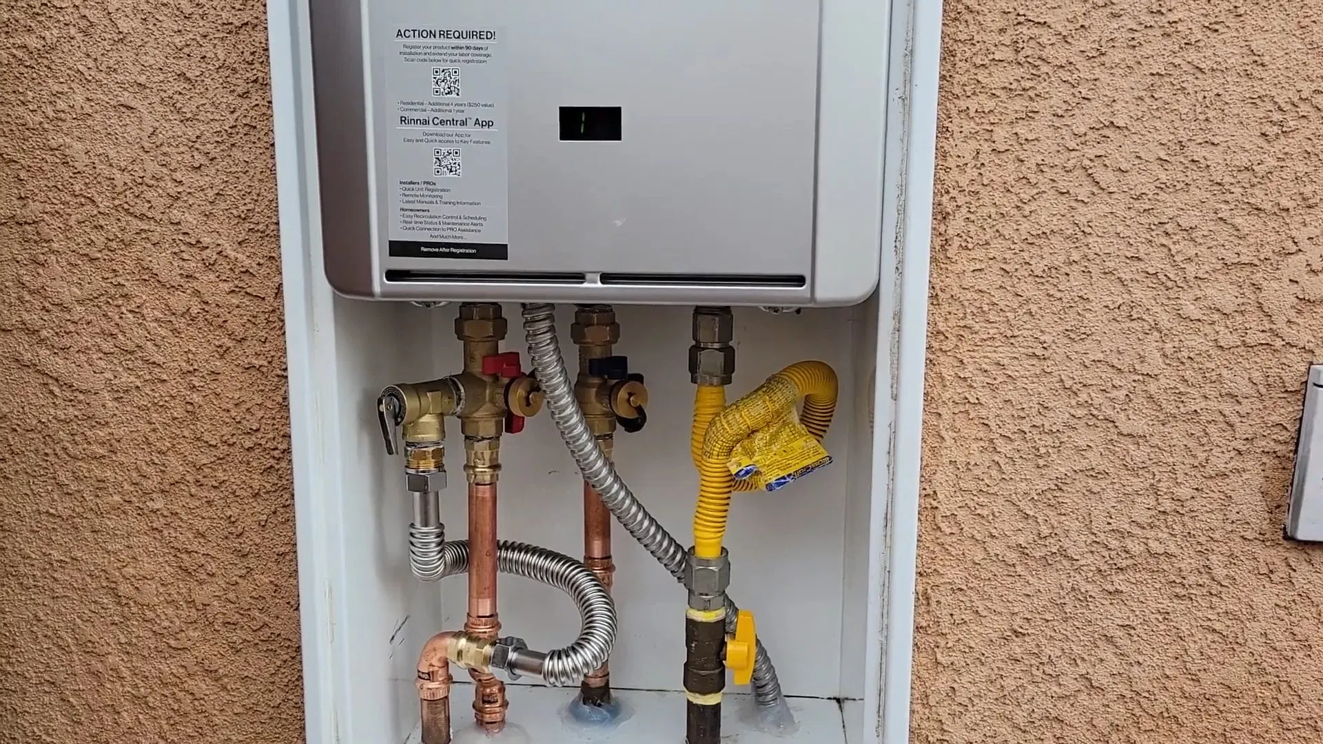 Tankless Water Heater Mounted On Stucco Wall shown for Tankless Water Heater in Dallas, GA in Dallas, Georgia.