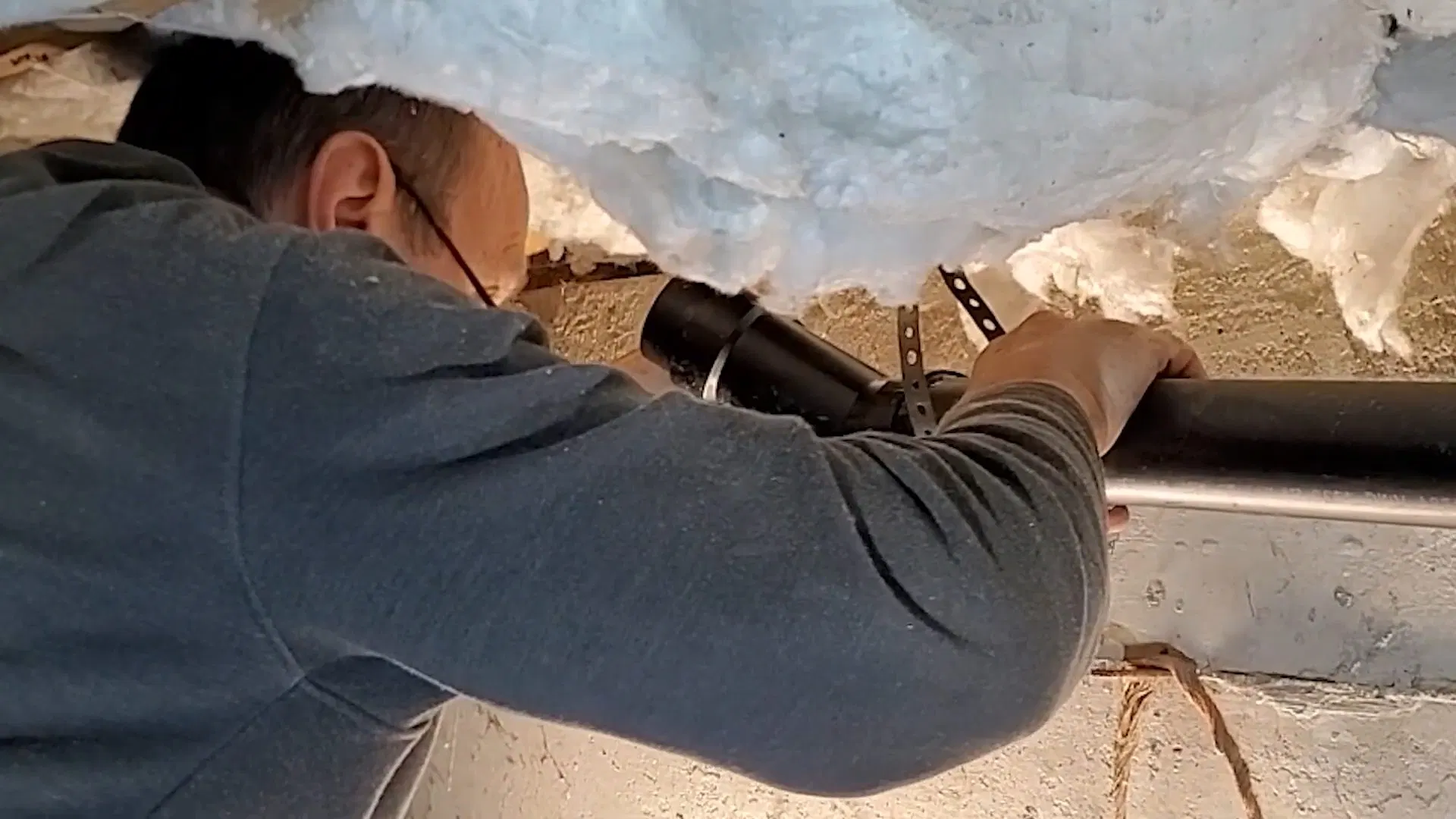 Technician Checking Crawlspace Drain Line shown for Why Does Our Drain Keep Clogging Again After It's Been Snaked? in Dallas, Georgia.