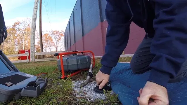 Technician Feeding Camera Into Main Sewer Line shown for Hydro Jetting in Dallas, GA in Dallas, Georgia.