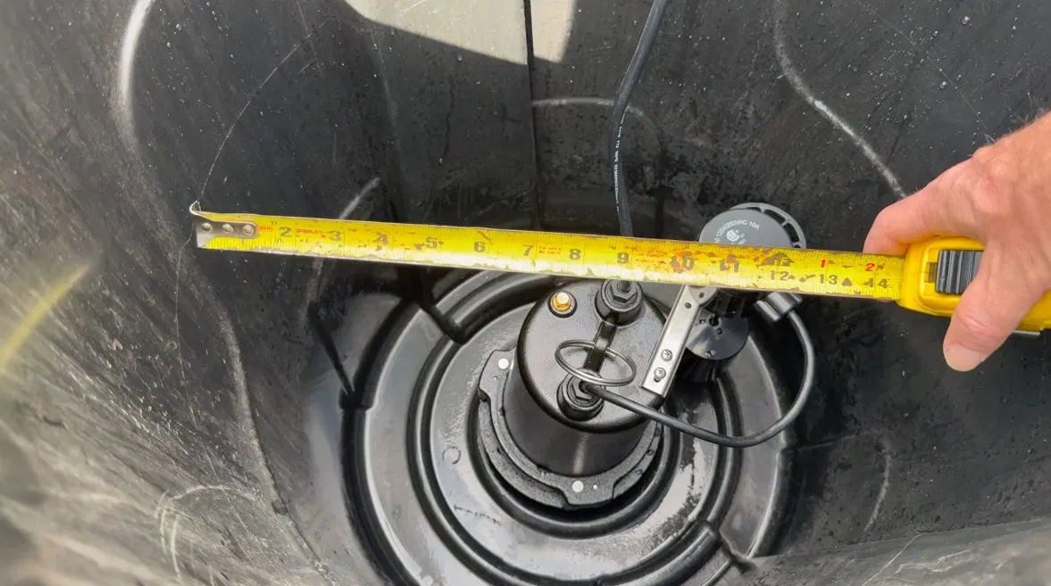 Technician Fitting Sump Pump Basin Lid shown for Areas we serve near Dallas, GA in Dallas, Georgia.