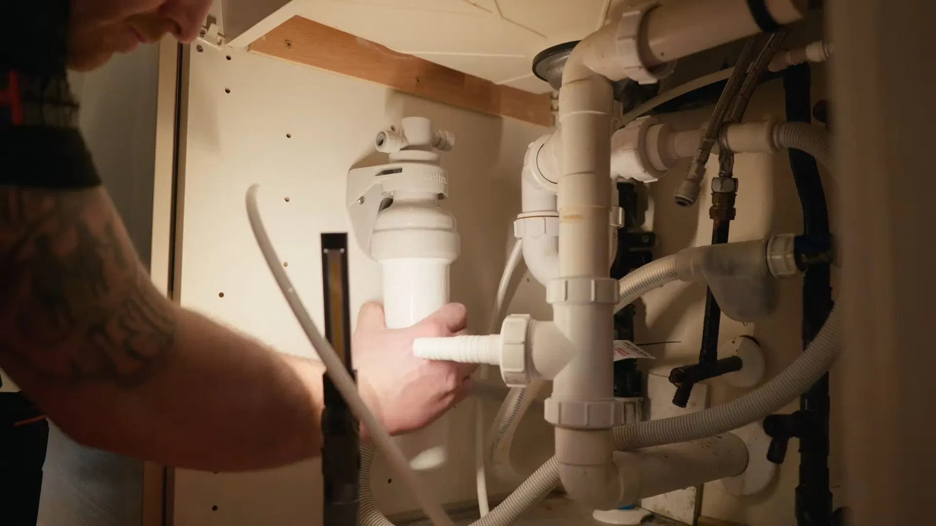 Technician Fitting Under Sink Filter Tubing shown for City Water or Well Water: What Actually Needs Filtering in Paulding County? in Dallas, Georgia.