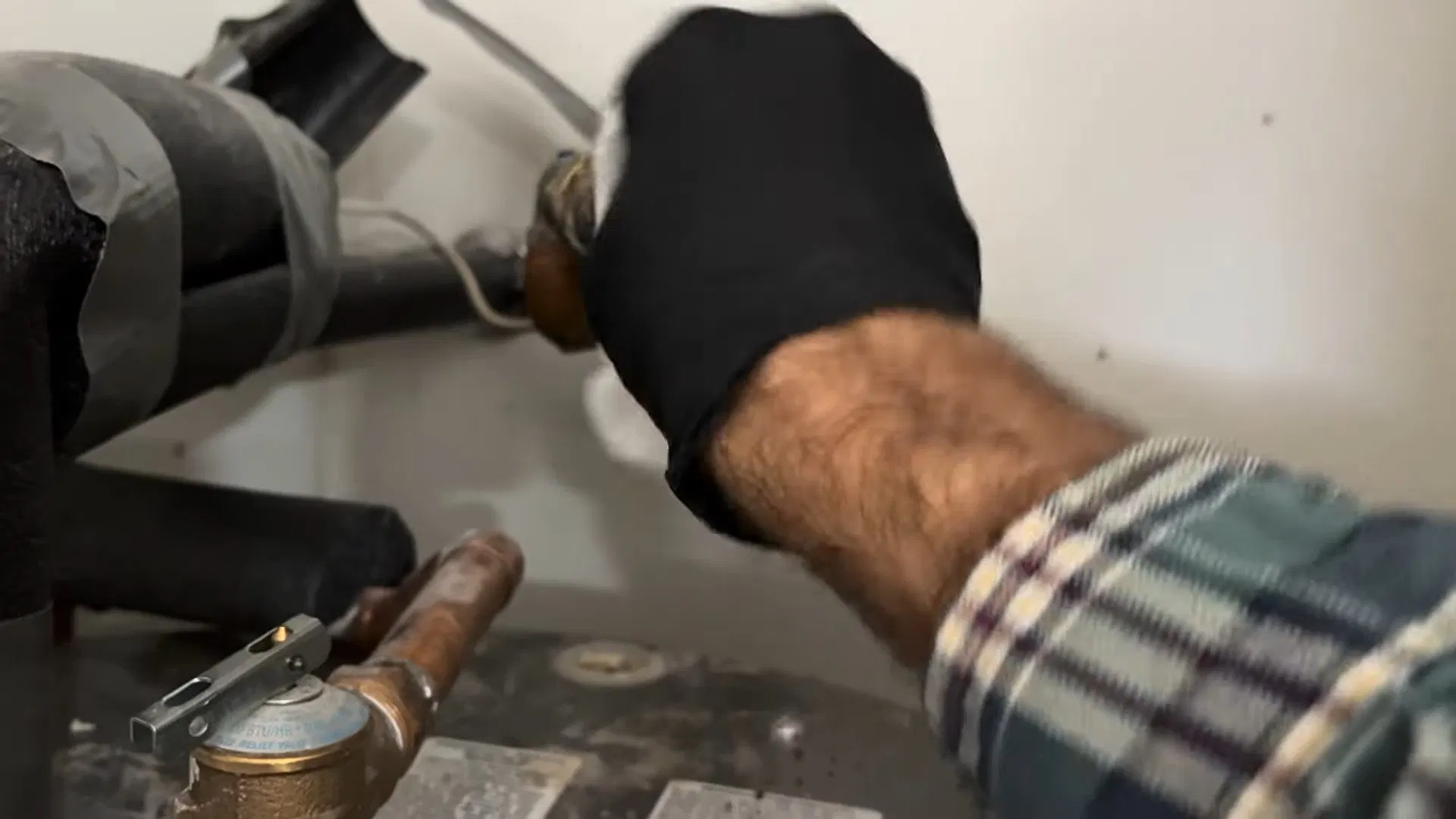 Technician Fixing Water Heater Inlet Hose shown for Water Heater Installation & Replacement in Dallas, GA in Dallas, Georgia.