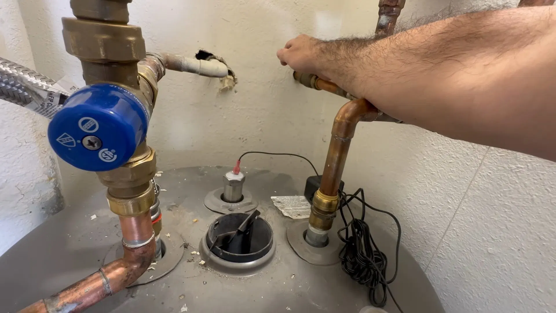 Technician Inspecting Water Heater Anode shown for Tankless Water Heater in Dallas, GA in Dallas, Georgia.