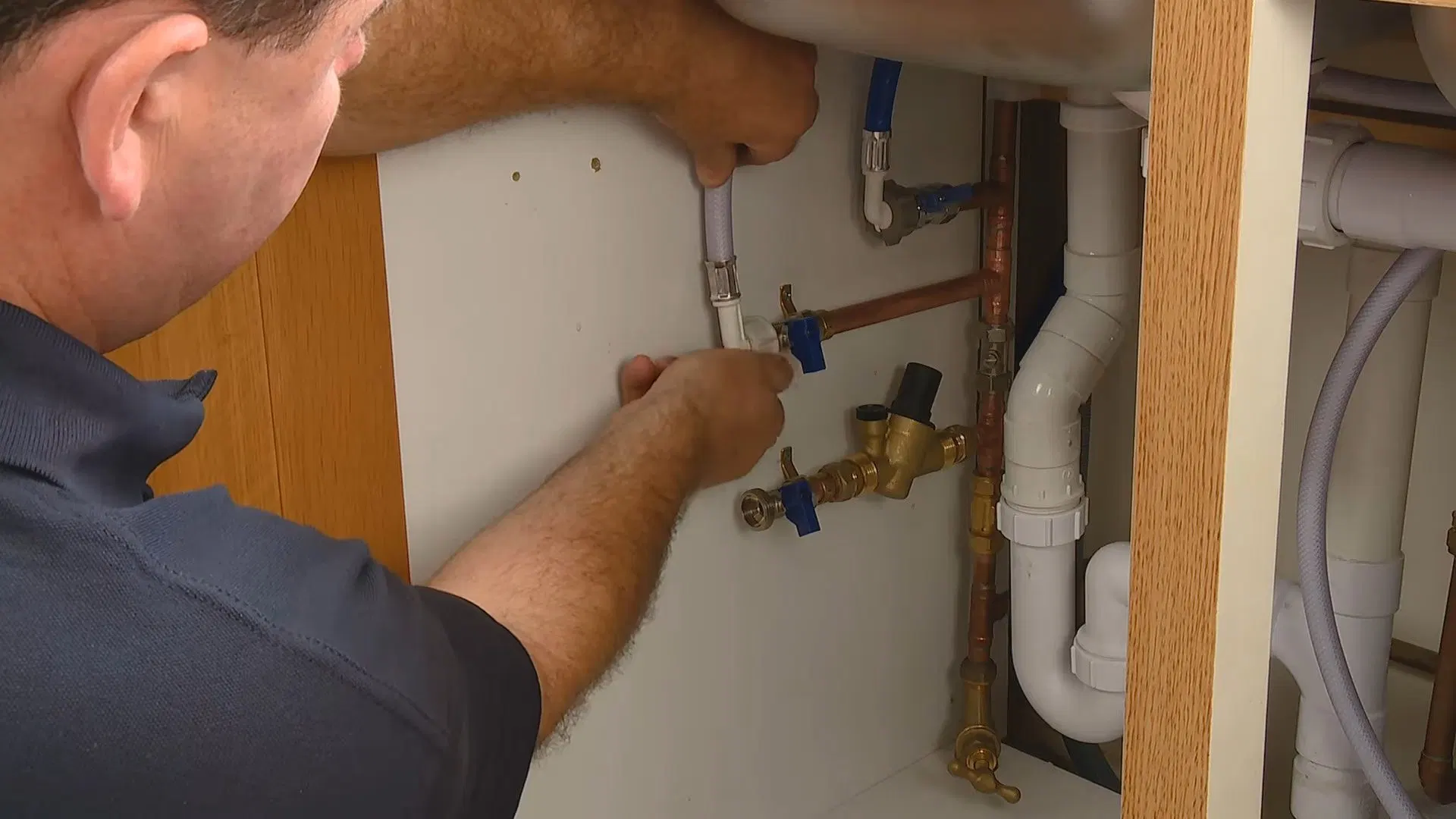 Technician Installing Softener Under Sink shown for City Water or Well Water: What Actually Needs Filtering in Paulding County? in Dallas, Georgia.