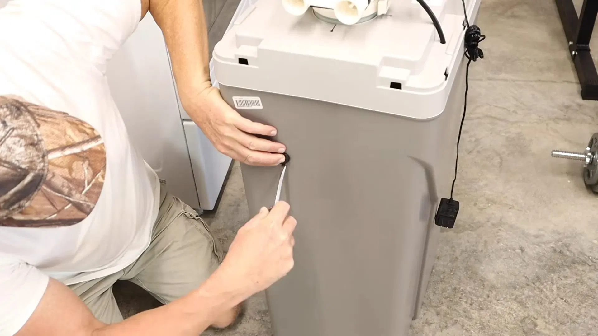 Technician Positioning Water Softener Cabinet shown for Water Heater Repair in Dallas, GA in Dallas, Georgia.