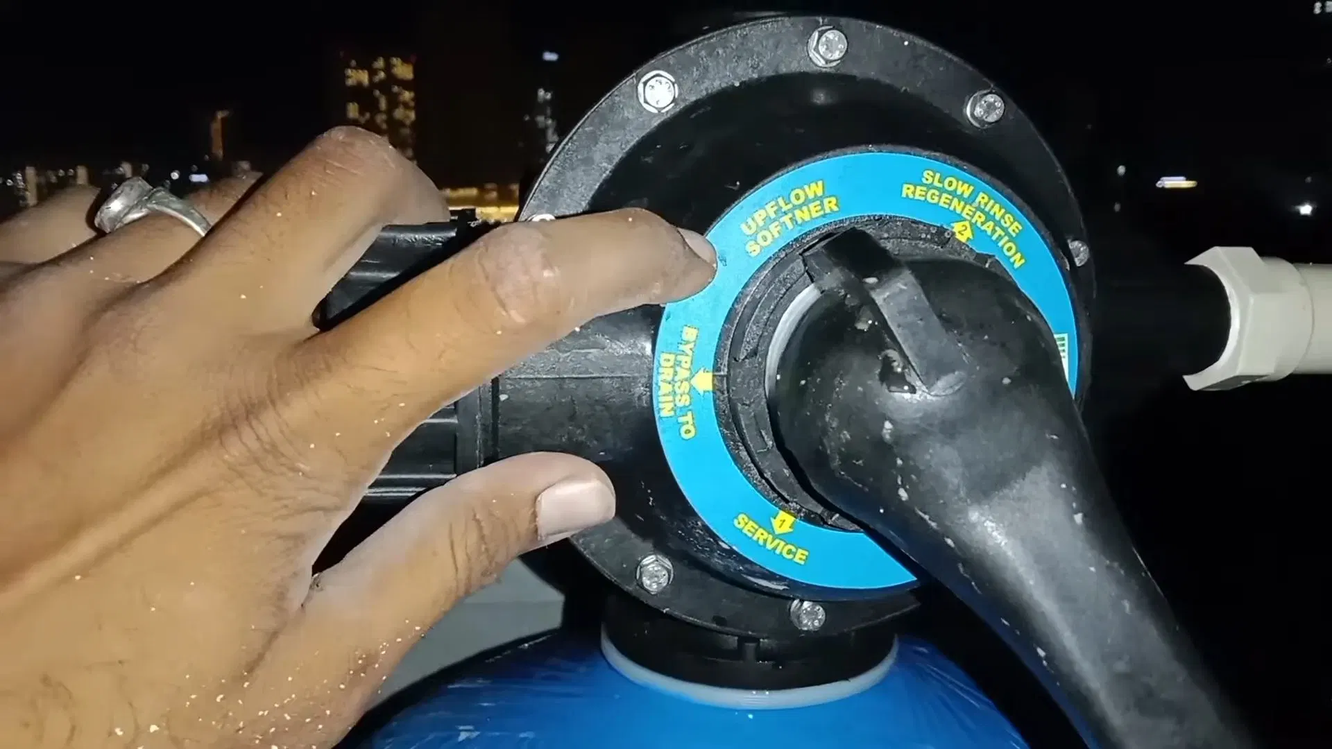 Technician Rotating Water Softener Control shown for Water Heater Repair in Dallas, GA in Dallas, Georgia.