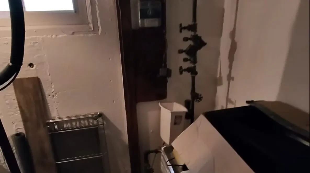Technician Testing Backflow Valve In Utility Room shown for Plumbing services in Dallas, GA in Dallas, Georgia.
