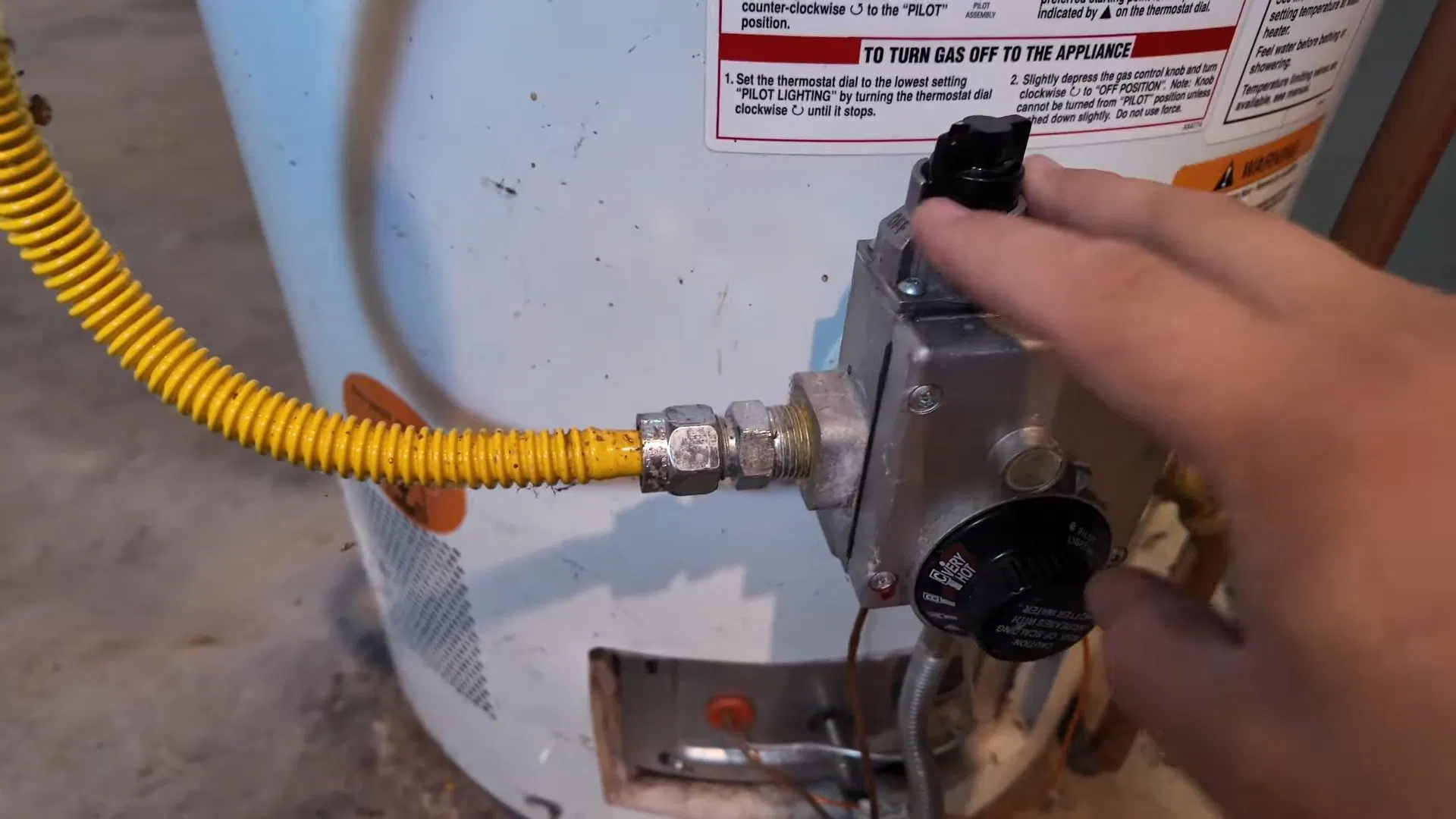 Technician Turning Gas Valve On Water Heater shown for Gas Line Installation & Repair in Dallas, GA in Dallas, Georgia.