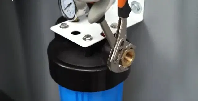 Tightening Filter Head Fitting With Pliers shown for City Water or Well Water: What Actually Needs Filtering in Paulding County? in Dallas, Georgia.