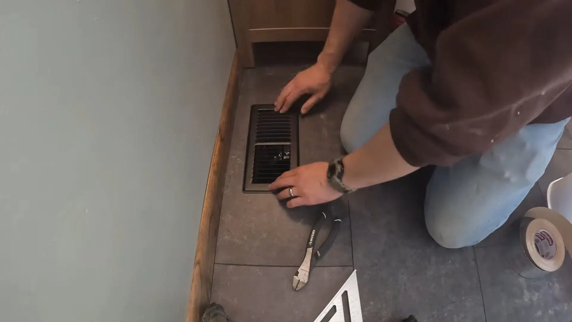 Tile Installer Working On Bathroom Floor shown for Toilet Repair & Installation in Dallas, GA in Dallas, Georgia.
